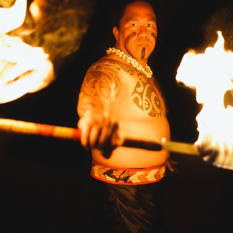 A man holding up his fire knife