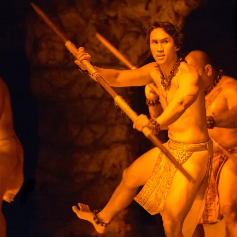 Men on stage looking fierce as they dance