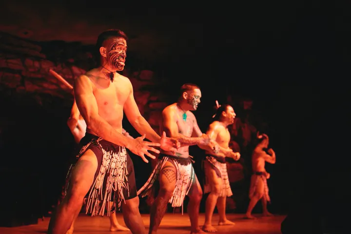 Three Maori men looking fierce on stage