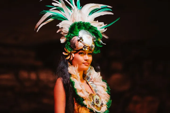 A woman on stage wearing a crown made of flowers