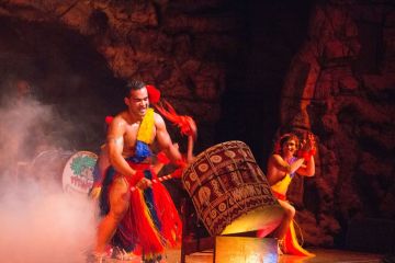 A man banging on Tonga drums