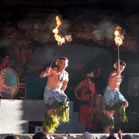Two men dancing with torches