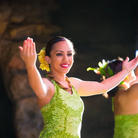 A woman hula dancing on stage during a performance
