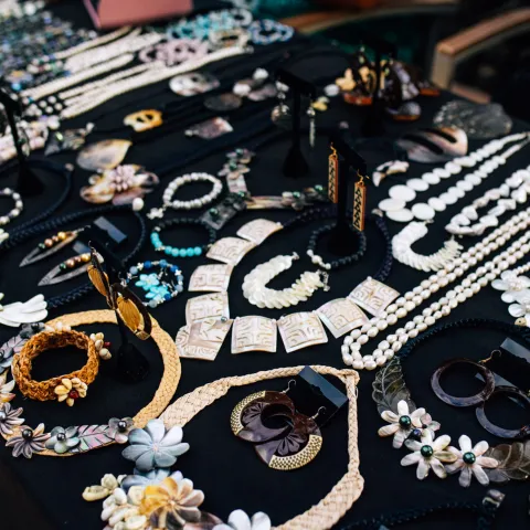 a person sitting at a table with a birthday cake