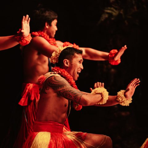 a man and a woman standing in a dark room